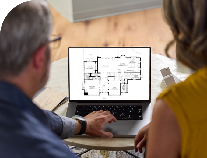 Two people looking at a Matterport floor plan on a computer screen