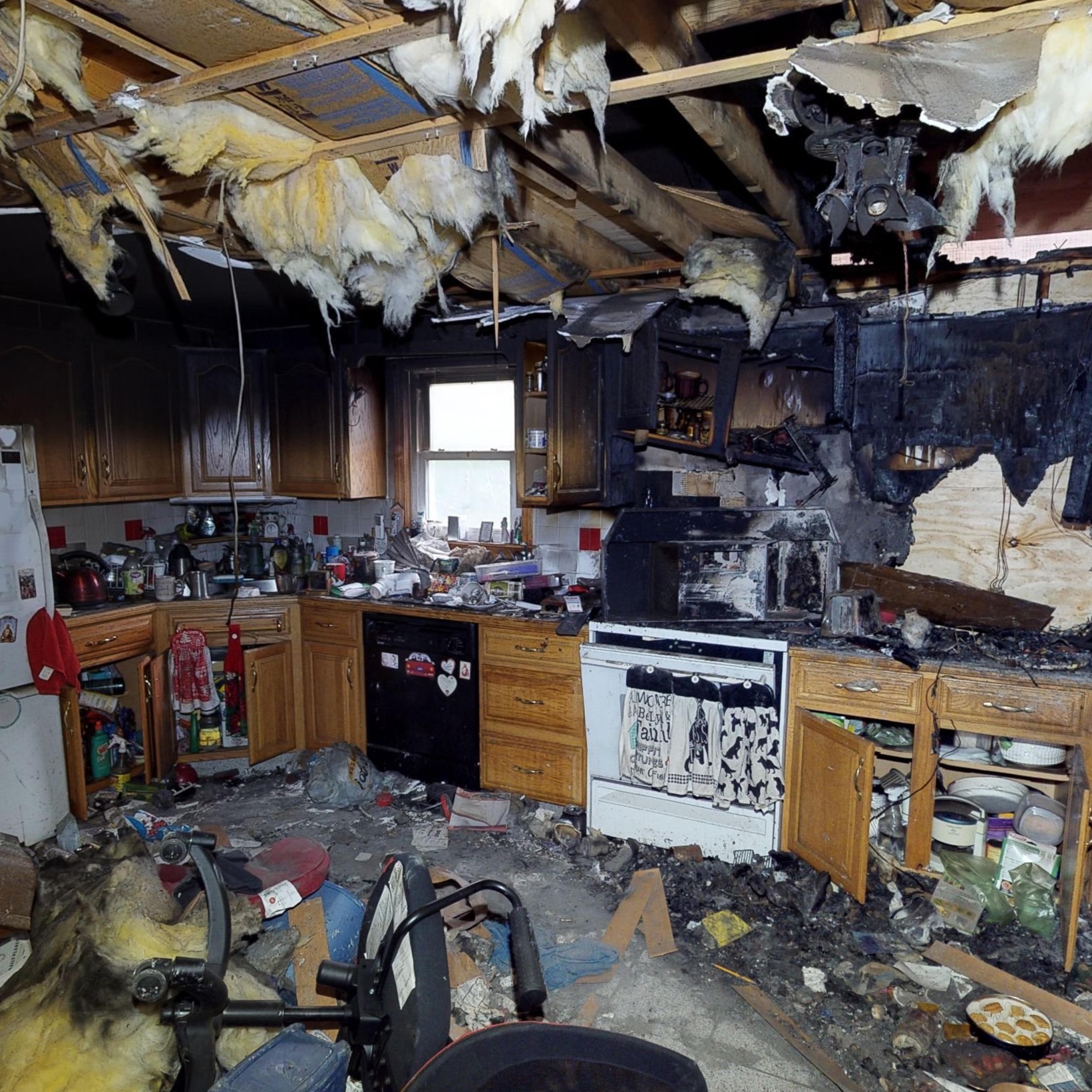 Extreme floor to ceiling property damage fills a residential kitchen